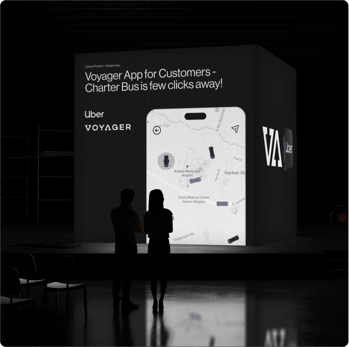 Voyager customer app showcased on a large exhibition display with a charter bus booking map interface