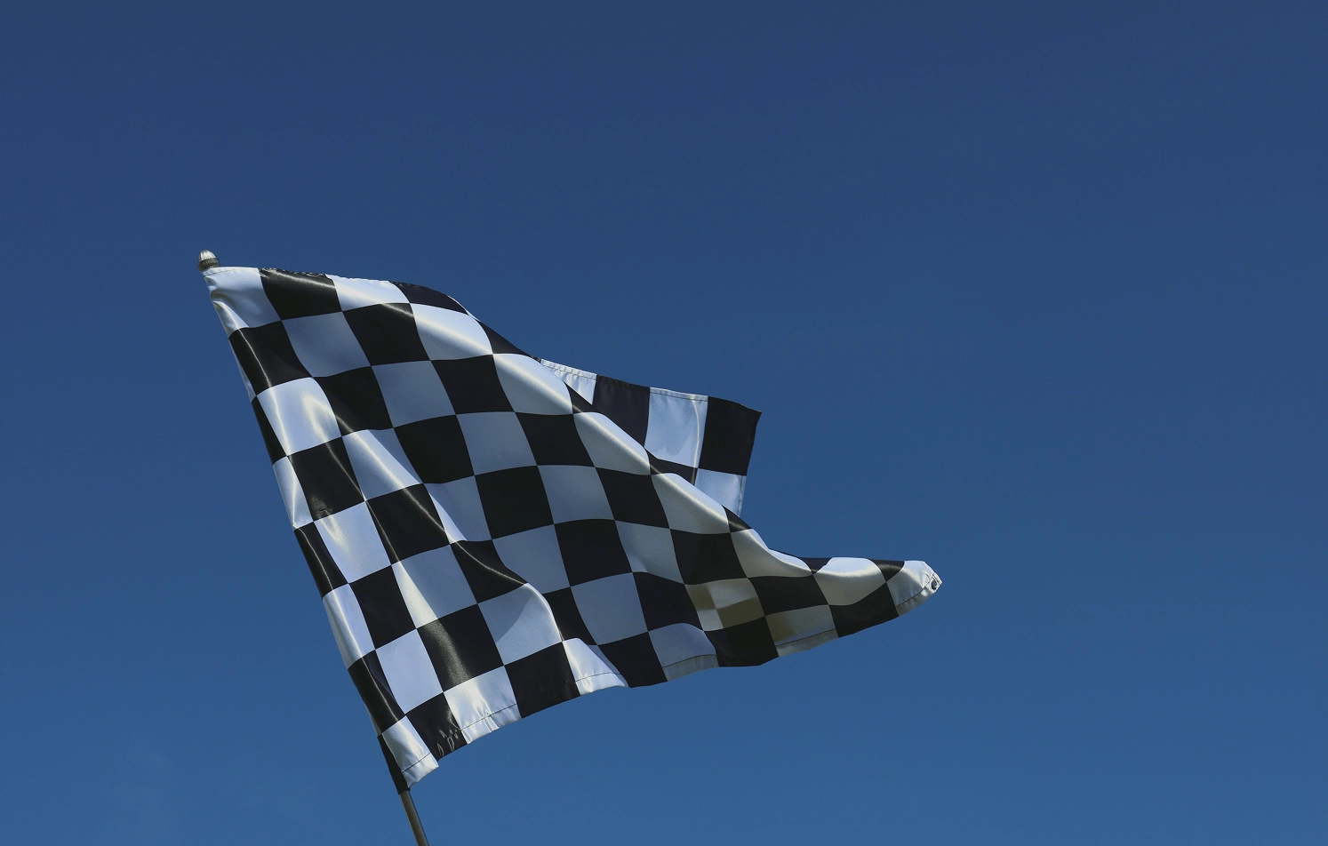 Checkered Flag Checkered flag waving against blue sky