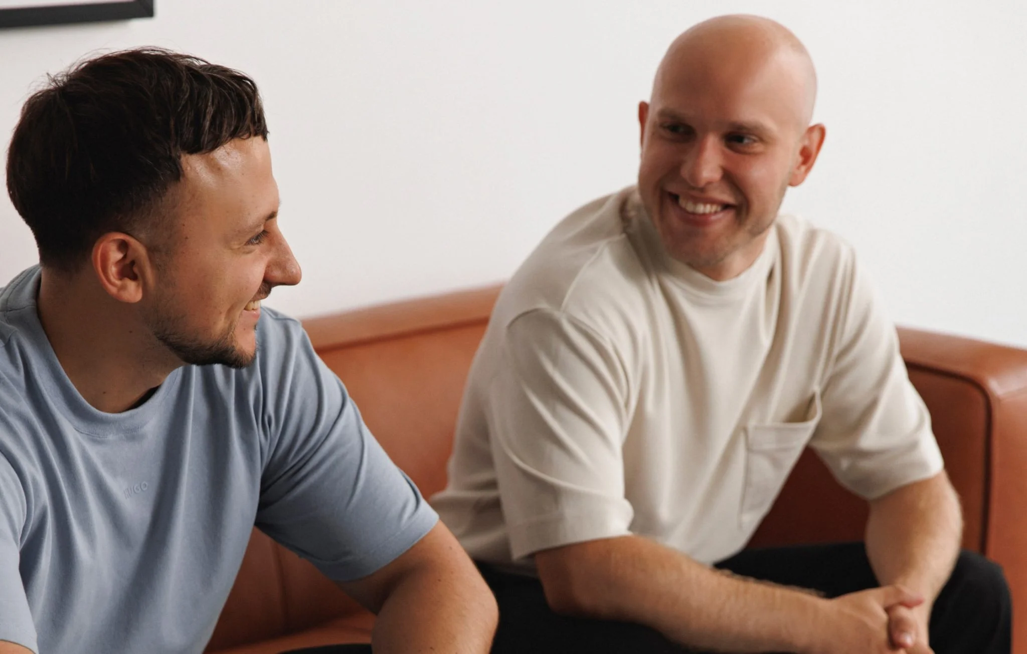 Two colleagues smiling on sofa