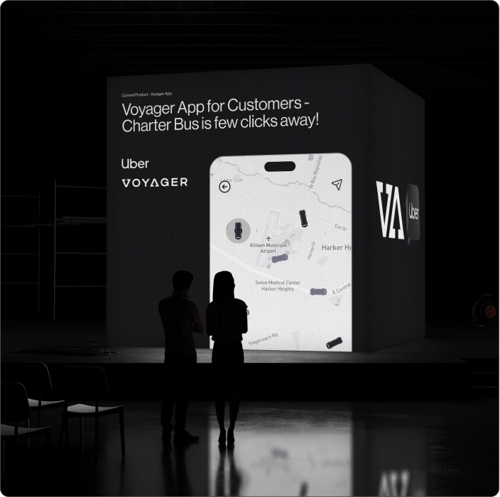 Voyager customer app showcased on a large exhibition display with a charter bus booking map interface